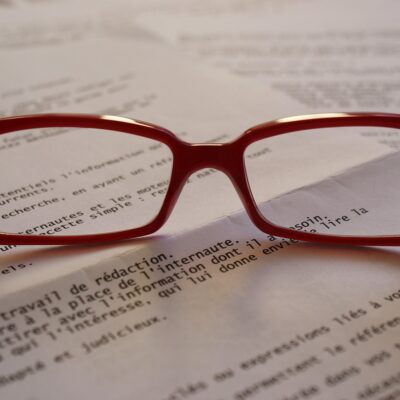 Glasses sit on typed paper